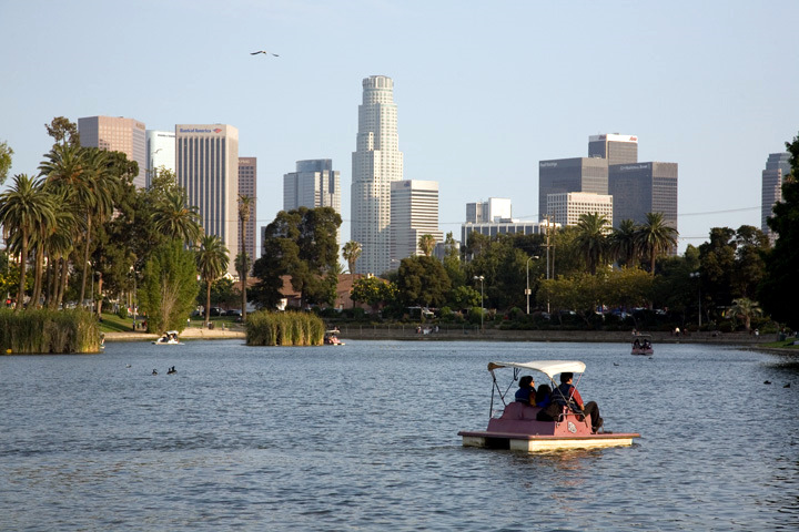 Paddle boat on Echo Park Lake with downtown Los Angeles towers beyond
