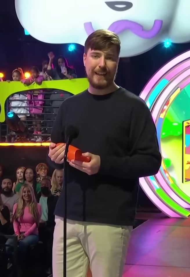 Jimmy Donaldson on stage at the Kids Choice Awards holding an orange prop